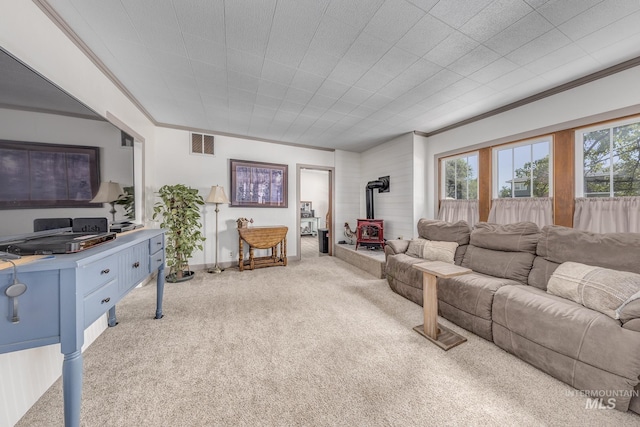 300 N 10th St, Payette, ID 83661 - living room with a wood stove, light carpet, and crown molding