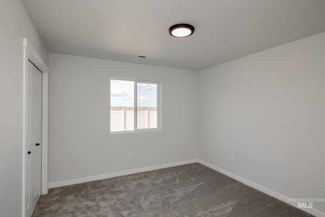 unfurnished bedroom with a closet, carpet flooring, and baseboards