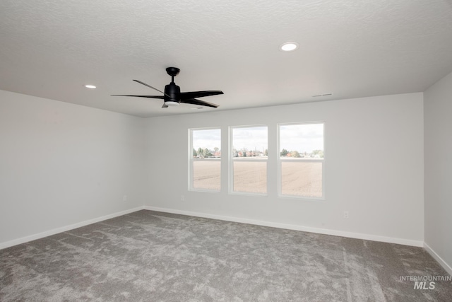 carpeted spare room with ceiling fan, baseboards, a textured ceiling, and recessed lighting