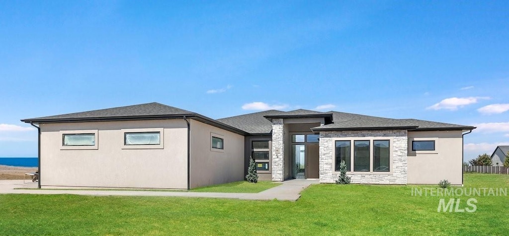4233 N 2744 E, Twin Falls, ID 83301 - back of property with stone siding and a lawn