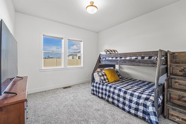bedroom with visible vents, carpet floors, and baseboards
