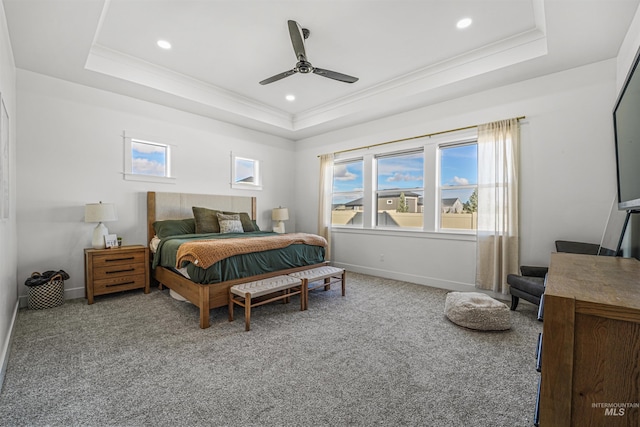 bedroom featuring a raised ceiling, carpet floors, and ornamental molding