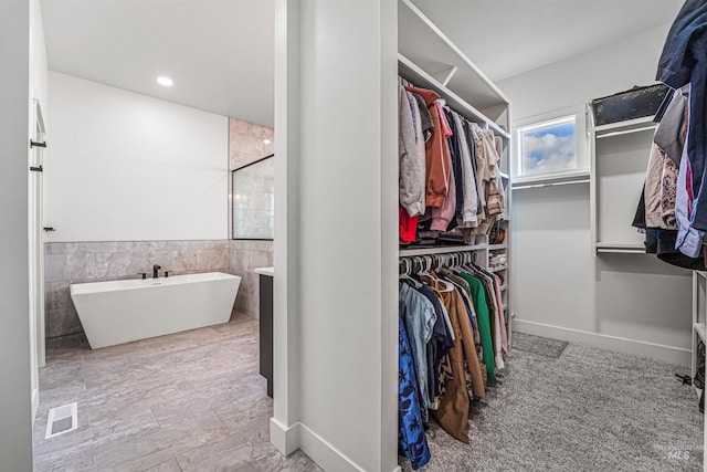 spacious closet featuring visible vents