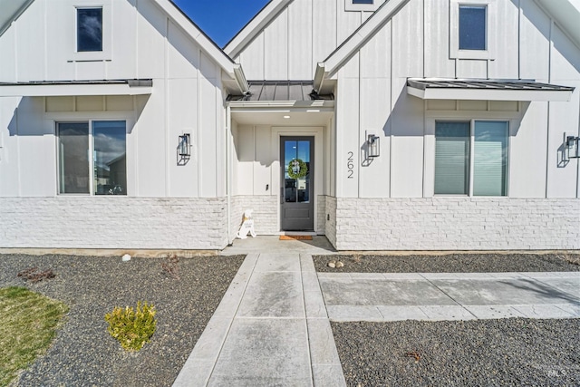 property entrance with a standing seam roof, board and batten siding, and metal roof