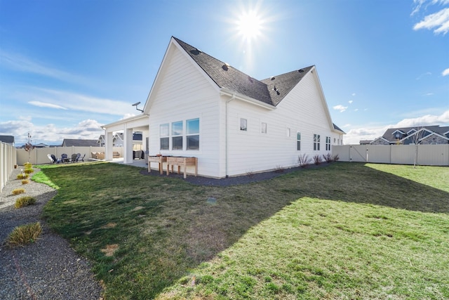 back of property with a fenced backyard, a yard, and a patio