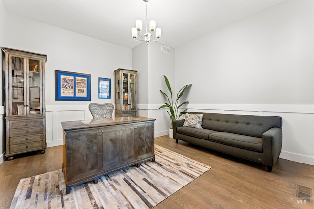 office space with hardwood / wood-style floors and a chandelier