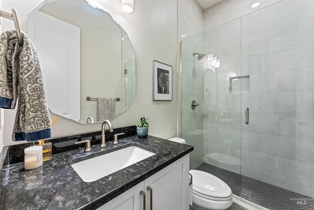 bathroom with vanity, an enclosed shower, and toilet