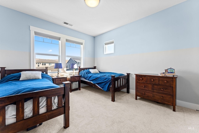 bedroom featuring light carpet