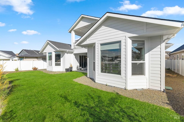 back of property featuring an outbuilding and a lawn