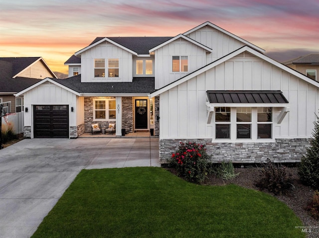 modern farmhouse with a yard and a garage