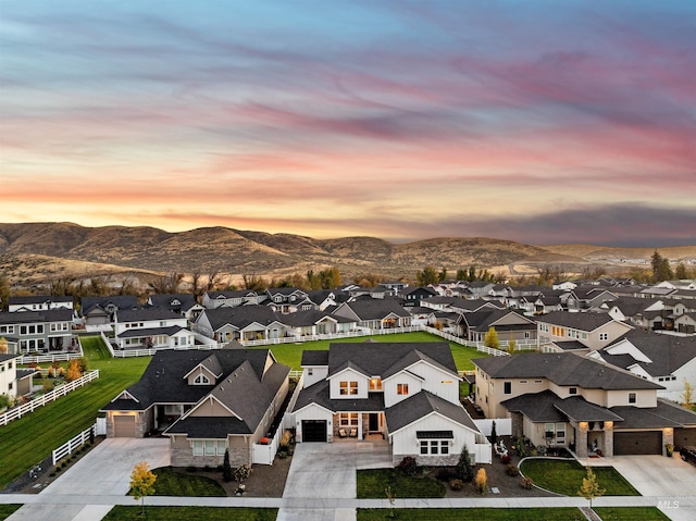 aerial view at dusk featuring a mountain view