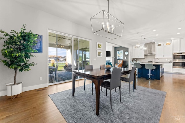 dining space featuring a chandelier and wood-type flooring