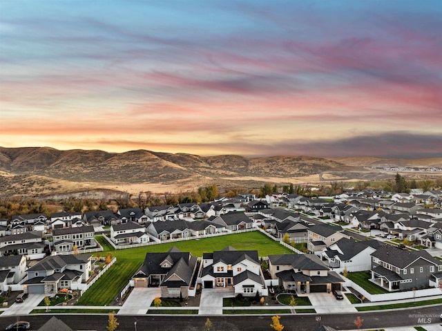 aerial view at dusk featuring a mountain view