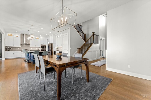 dining room with an inviting chandelier and dark wood-type flooring