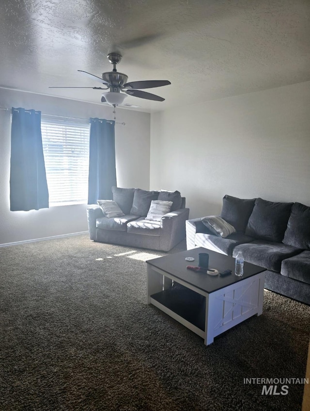 carpeted living room with ceiling fan and a textured ceiling