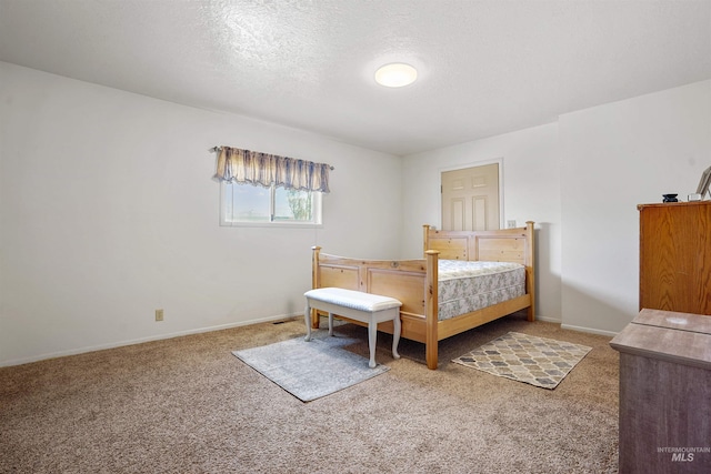 carpeted bedroom with a textured ceiling and baseboards