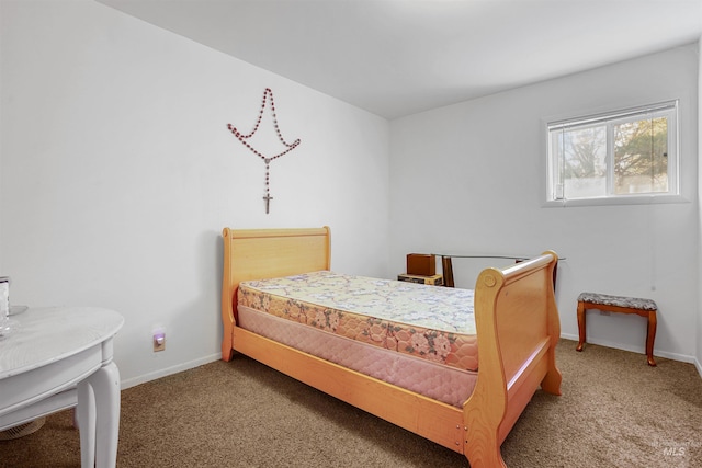 carpeted bedroom featuring baseboards