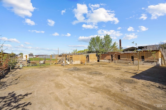 view of yard featuring an outbuilding and an exterior structure