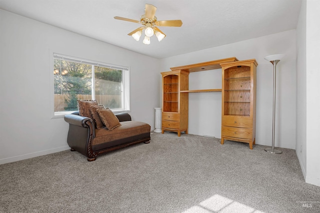 living area with light carpet and a ceiling fan