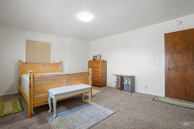 bedroom with carpet floors and baseboards