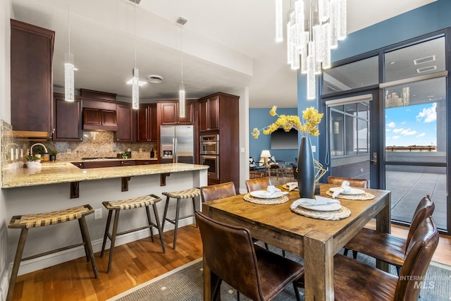 dining area featuring wood finished floors and visible vents