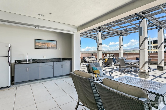 view of patio / terrace featuring outdoor dining space, area for grilling, and a sink