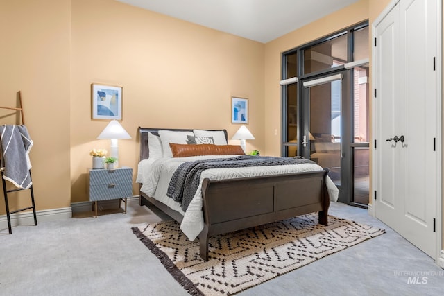 bedroom featuring baseboards, carpet, and access to outside