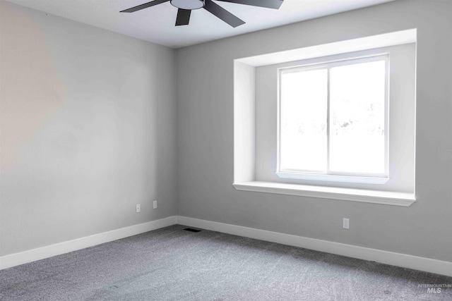 empty room featuring ceiling fan, a healthy amount of sunlight, and carpet floors