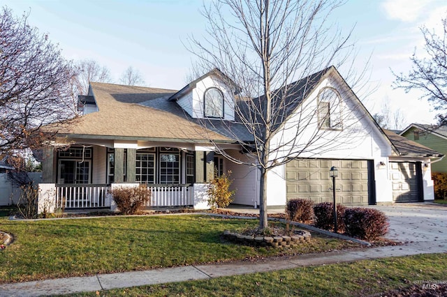 view of front of house featuring a front lawn, a porch, and a garage