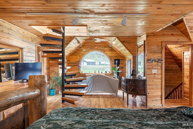 bedroom with wood-type flooring, wooden walls, wood ceiling, and lofted ceiling