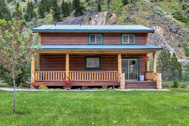 log-style house with a front lawn and a porch