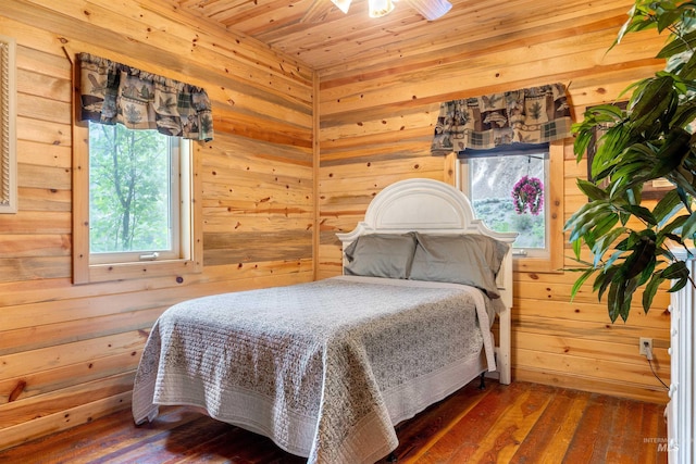 bedroom featuring wood walls, hardwood / wood-style floors, and wood ceiling