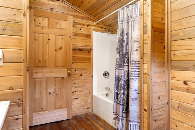 bathroom with hardwood / wood-style floors, vaulted ceiling, shower / bath combination with curtain, wood walls, and wooden ceiling