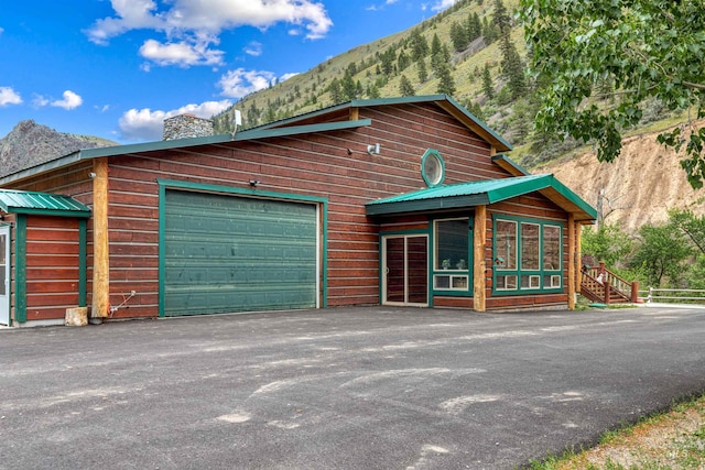 view of front facade featuring a garage and a mountain view