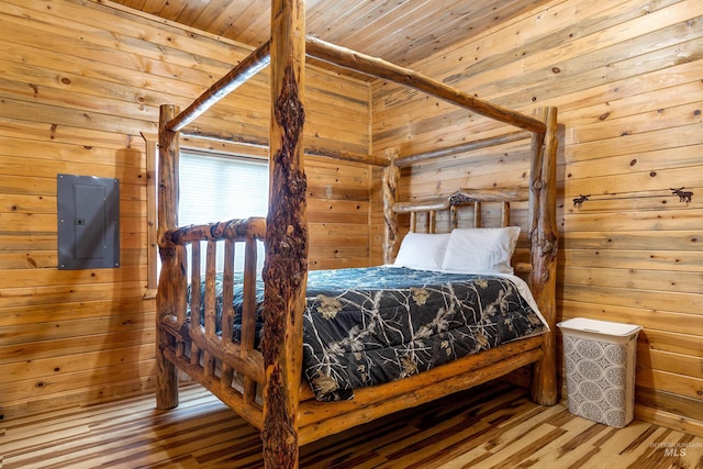 bedroom featuring wood-type flooring, wooden walls, and wooden ceiling