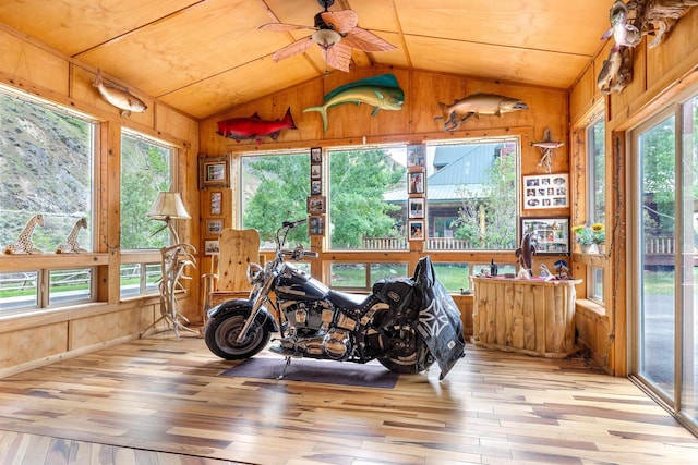 sunroom with a healthy amount of sunlight, wood ceiling, and vaulted ceiling