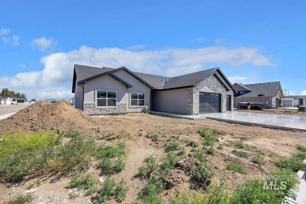 1552 W Ruby, Rupert, ID 83350 - single story home featuring stone siding, an attached garage, driveway, and stucco siding