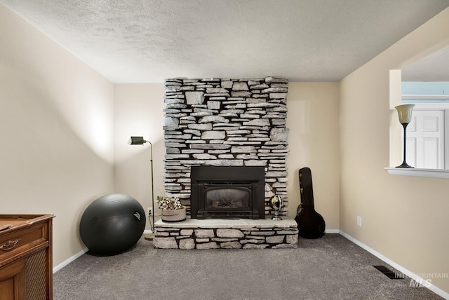 interior space with carpet, a textured ceiling, and a fireplace