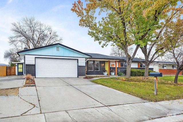 ranch-style home featuring a garage and a front lawn