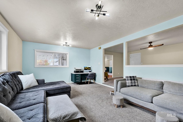 living room with carpet flooring, a textured ceiling, and ceiling fan