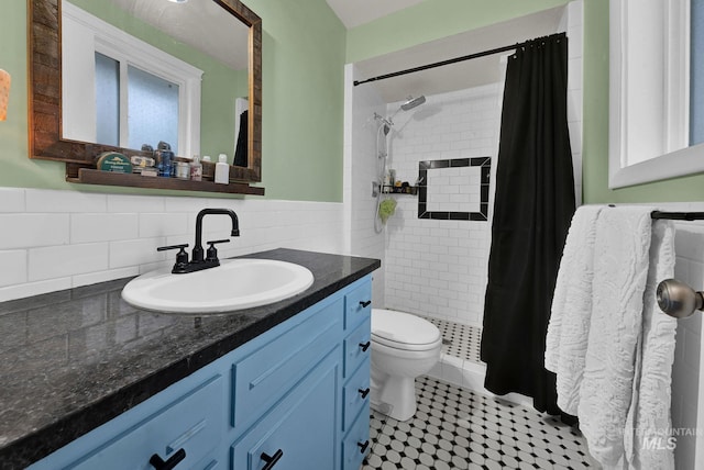 bathroom featuring vanity, tile patterned flooring, toilet, walk in shower, and tile walls