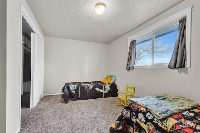 bedroom featuring carpet flooring and a textured ceiling