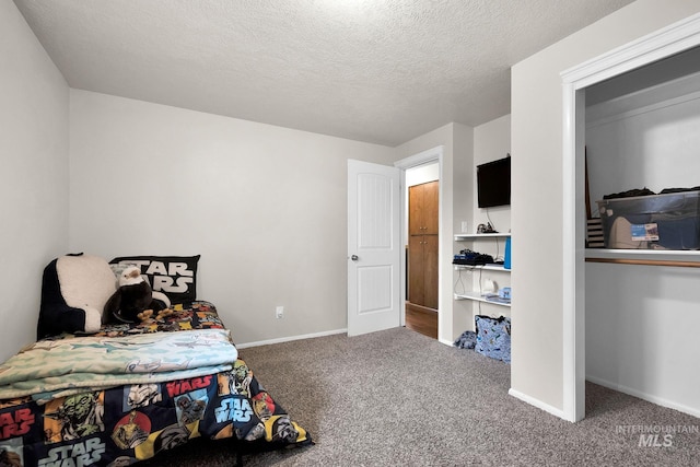 carpeted bedroom with a textured ceiling