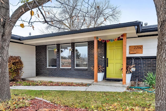 doorway to property featuring a porch