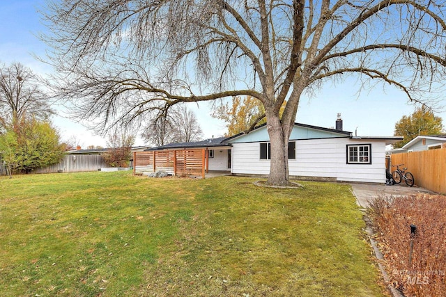 rear view of house with a yard