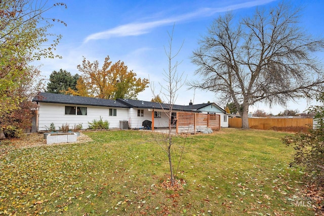 rear view of house featuring a patio area, a yard, and central AC