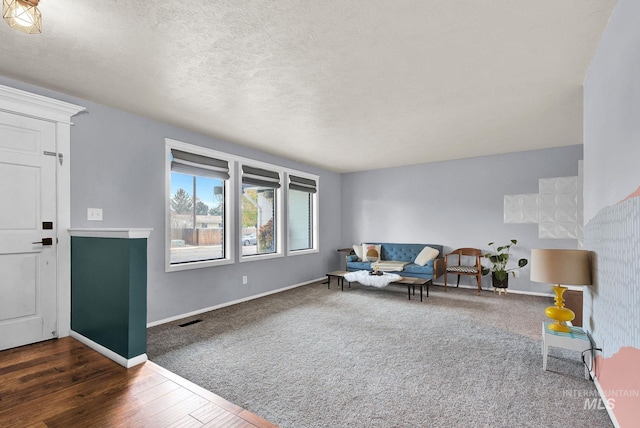 living room with dark hardwood / wood-style floors and a textured ceiling