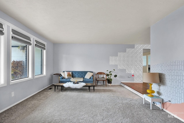 carpeted living room with a textured ceiling