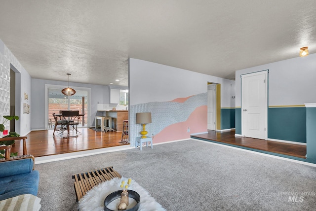 living room with wood-type flooring and a textured ceiling