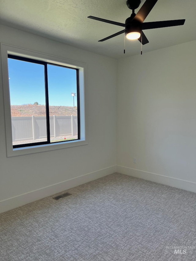 3075 N Costa Madera Ave, Star, ID 83669 - carpeted empty room with healthy amount of natural light, baseboards, and ceiling fan